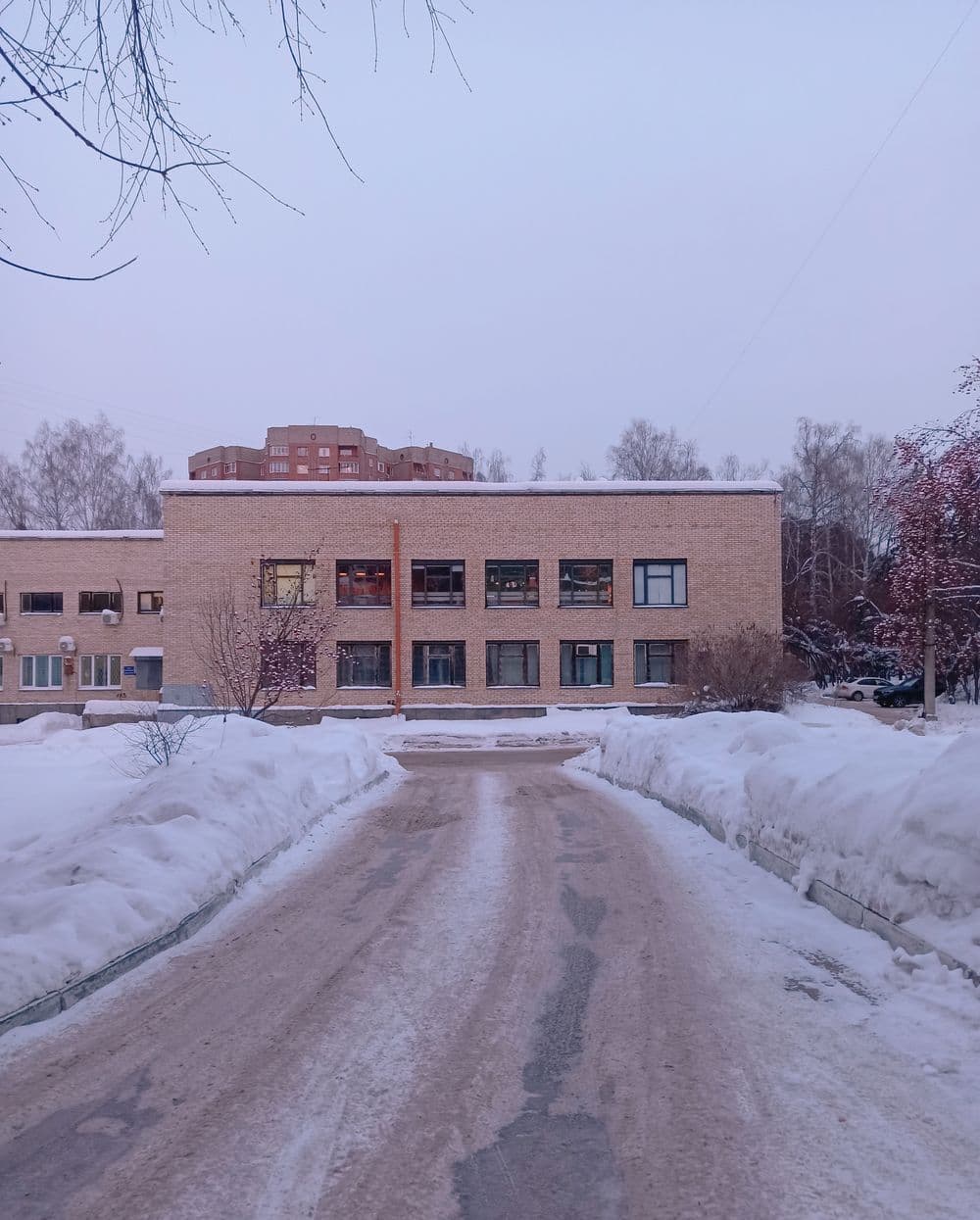 Cleared access road between snowbanks; illustrative stock photograph